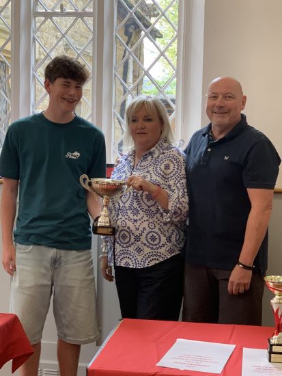 Dan and Mark, Saxon Spears receive the cup from Charlie.